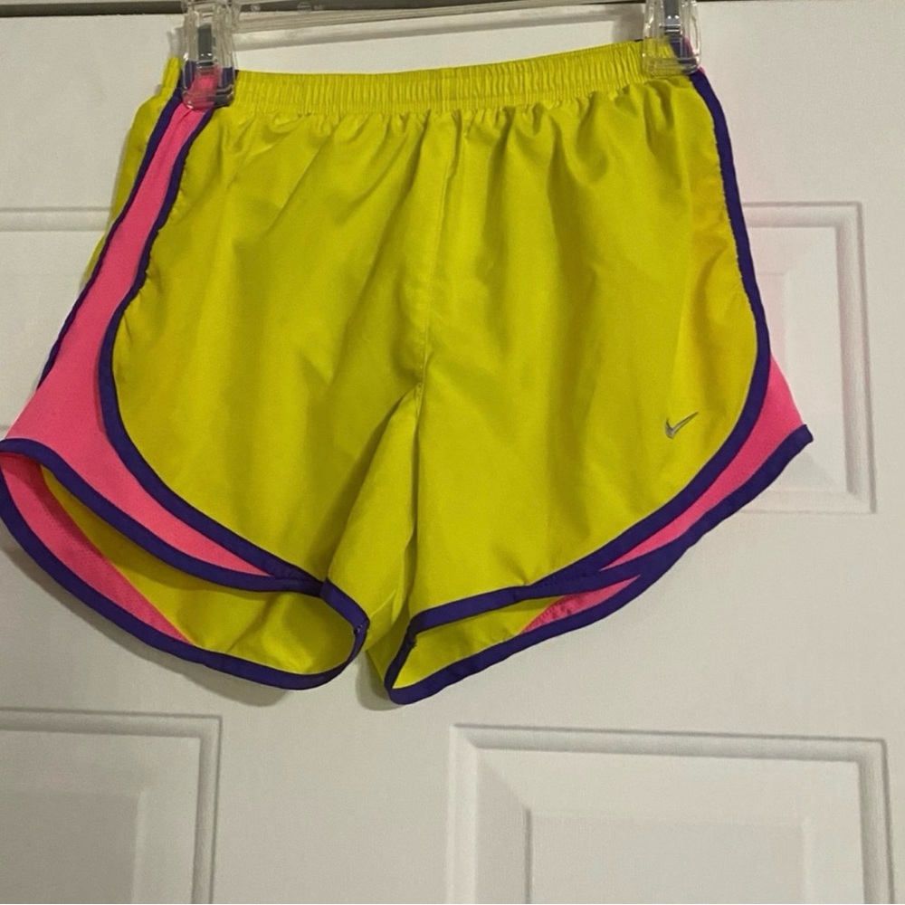 Nike Women's Vibrant Yellow and Pink Athletic Shorts are a size small.